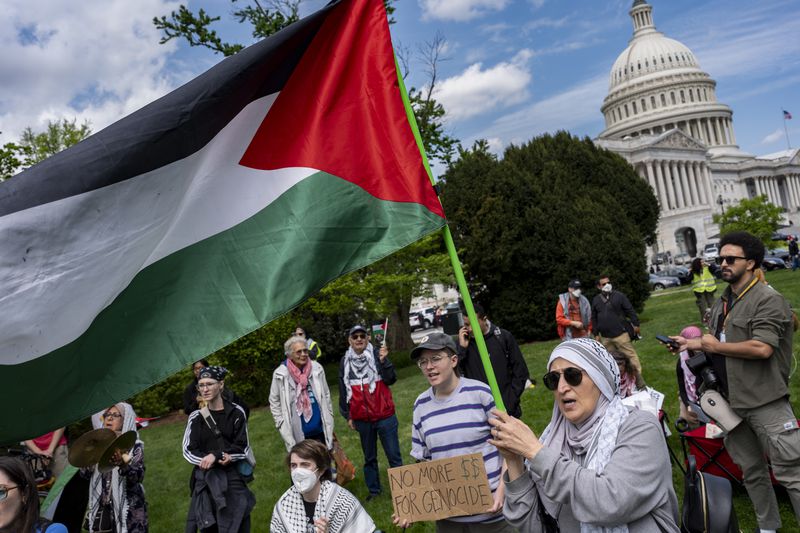 Pro-Palestinian activists demonstrate outside the Capitol in Washington, Saturday, April 20, 2024, as the House prepares to vote on approval of $95 billion in foreign aid for Ukraine, Israel and other U.S. allies. (AP Photo/J. Scott Applewhite)