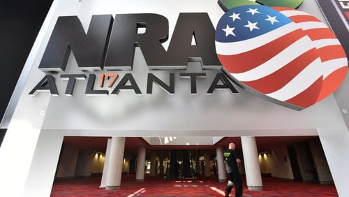 Workers put the finishing touches on the convention floor at the Georgia World Congress Center for the 146th NRA Annual Meetings and Exhibits in Atlanta, which continues through Sunday. (HYOSUB SHIN / HSHIN@AJC.COM)