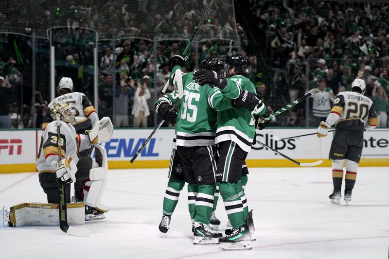Dallas Stars' Matt Duchene and Tyler Seguin, center right, and others celebrate a goal scored by Duchene as Vegas Golden Knights' Adin Hill (33) looks on in the first period in Game 5 of an NHL hockey Stanley Cup first-round playoff series in Dallas, Wednesday, May 1, 2024. (AP Photo/Tony Gutierrez)
