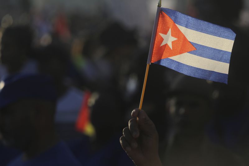 A person waves a Cuban flag during a gathering marking International Workers' Day at Anti-Imperialist Square in Havana, Cuba, Wednesday, May 1, 2024. (AP Photo/Ariel Ley)