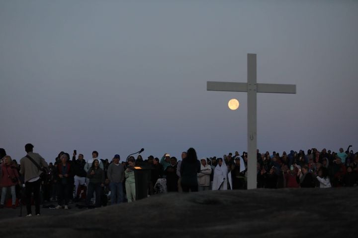 People crowd around the cross at the top of Stone Mountain during the 76th annual Easter Sunrise Service on Sunday, April 17, 2022. Miguel Martinez/miguel.martinezjimenez@ajc.com