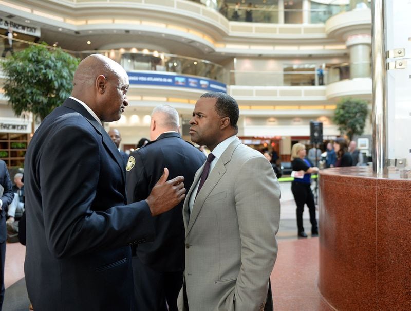 Then-Hartsfield-Jackson International Airport General Manager Miguel Southwell, left, talks with then-Mayor Kasim Reed following a November 2015 press conference. KENT D. JOHNSON / AJC