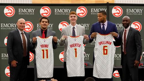 Atlanta Hawks first-round draft picks, Trae Young (11), Kevin Huerter (1) and Omari Spellman (6) pose with general manager Travis Shlenk (left) and head coach Lloyd Pierce during a news conference Monday, June 25, 2018, in Atlanta.