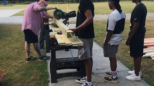 Archer High engineering students help build a chicken coop for Lovin Elementary. The joint project allows students at both schools to experience STEM curriculum. COURTESY OF GWINNETT COUNTY PUBLIC SCHOOLS