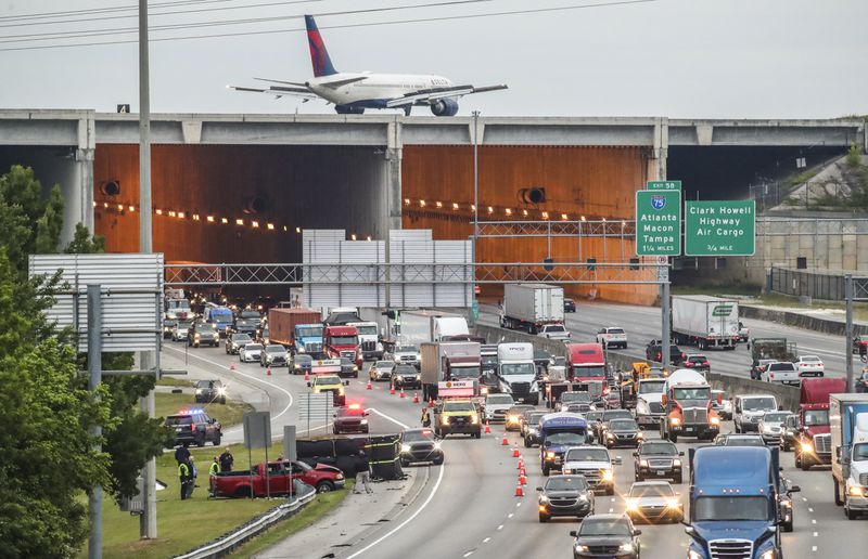 April 26, 2023 Clayton County: A single-vehicle fatal crash investigation on I-285 West closed an exit ramp heading toward Hartsfield-Jackson International Airport for hours Wednesday morning, April 26, 2023. (John Spink / John.Spink@ajc.com)

