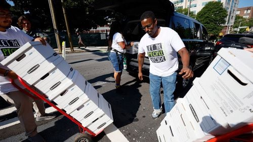 Forest defenders assisted in unloading sixteen boxes containing more than 100,000 signatures from a petition, on Sept. 10, 2023. (Miguel Martinez/The Atlanta Journal-Constitution/TNS)