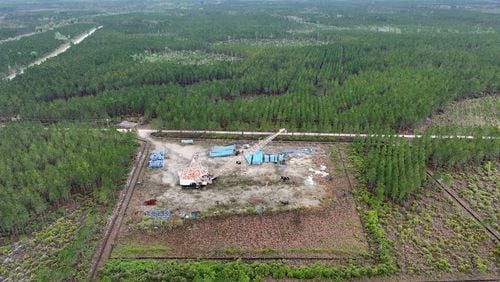 A drone photograph shows part of the Twin Pines mine site, where equipment is stationed, on March 18, 2024, in Charlton County, Georgia. The site is located less than three miles from the Okefenokee National Wildlife Refuge, the largest U.S. refuge east of the Mississippi River. The Georgia Environmental Protection Division has released draft permits to Twin Pines Minerals for a 582-acre mine that would extract titanium and other minerals from atop the ancient sand dunes on the swamp's eastern border, which holds water in the refuge. (Hyosub Shin/The Atlanta Journal-Constitution)