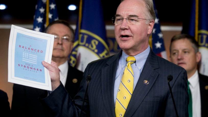 Representative Thomas "Tom" Price, a Republican from Georgia and chairman of the House Budget Committee, holds up a copy of the House Republicans' Fiscal Year 2016 budget proposal titled "A Balanced Budget for a Stronger America" during a news conference with other members of the budget committee in Washington, D.C., U.S., on Tuesday, March 17, 2015. U.S. House Republicans propose to balance the federal budget in less than 10 years by cutting spending by $5.5 trillion without raising taxes, the chamber's budget committee chairman said Tuesday in an opinion article. Photographer: Andrew Harrer/Bloomberg *** Local Caption *** Tom Price
