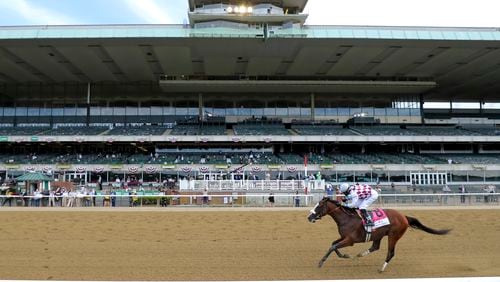 Tiz the Law (8), with jockey Manny Franco up, crosses the finish line in front of an empty grandstand to win the 152nd running of the Belmont Stakes horse race, Saturday, June 20, 2020, in Elmont, N.Y. (AP Photo/Seth Wenig)