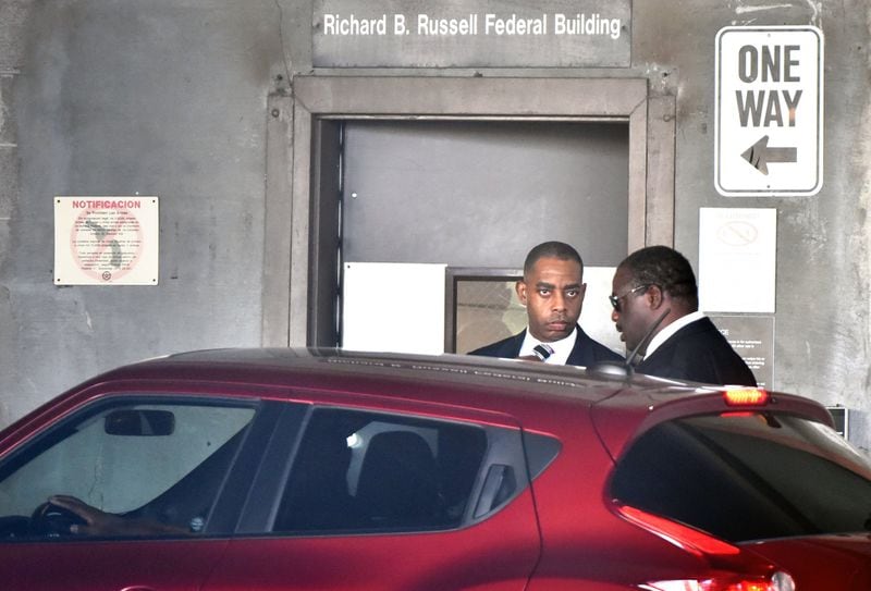 The city of Atlanta’s former chief purchasing officer, Adam Smith, left, leaves the federal courthouse after a hearing in September 2017. Smith pleaded guilty to accepting bribes, but he also agreed to cooperate with federal authorities. He is current serving a prison sentence at a federal facility in North Carolina. HYOSUB SHIN / HSHIN@AJC.COM