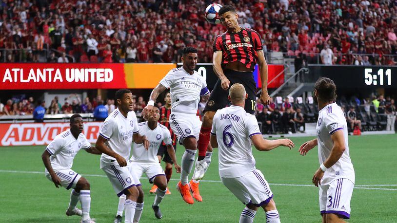 Atlanta United defender Miles Robinson trys to head a corner kick into the net against a host of Orlando City defenders during the first half in a MLS soccer match on Sunday, May 12, 2019, in Atlanta.  Curtis Compton/ccompton@ajc.com