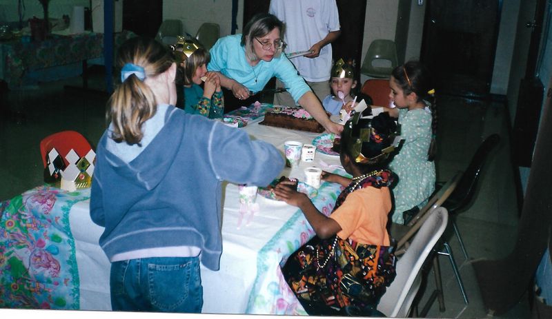 Leslie King serves birthday cake during daughter Olivia’s sixth birthday party at the former YWCA on Lawrenceville Highway in Decatur. (Courtesy of the King family)