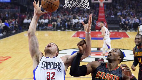 Los Angeles Clippers forward Blake Griffin, left, and Atlanta Hawks center Dwight Howard reach for a rebound during the first half of an NBA basketball game, Wednesday, Feb. 15, 2017, in Los Angeles. (AP Photo/Mark J. Terrill)