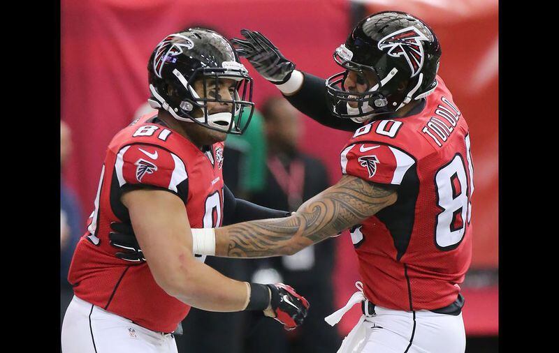 Falcons tight end Tony Moeaki (left) celebrates his touchdown with Levine Toilolo to take a 10-7 lead over the Saints during the second quarter in a football game on Sunday, Jan. 3, 2016, in Atlanta. Curtis Compton