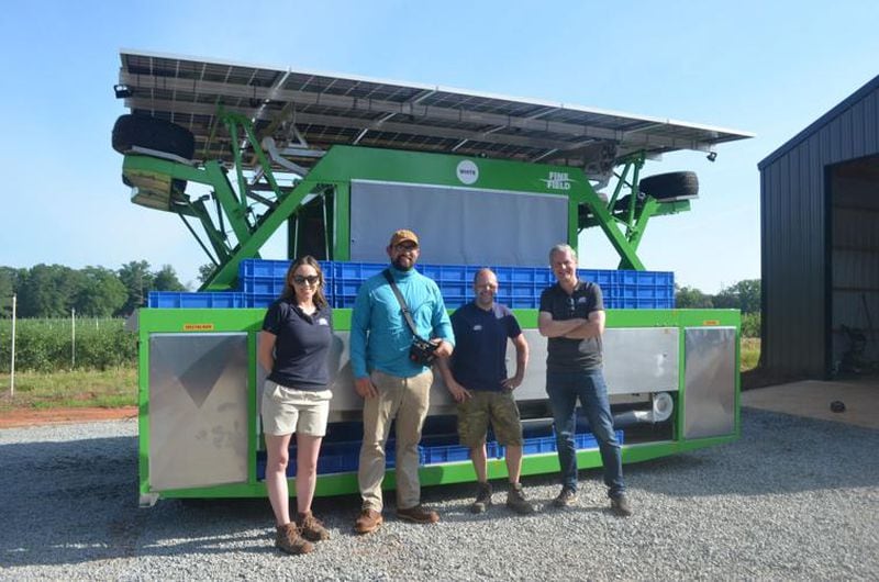 From left, Laina Gray, FineField's U.S. operations manager, Edison farmer Tyler Adams; Mike Jenssen of FineField; and Marcel Beleen, FineField's CEO, show off the Harvy500 at Adams' blueberry farm. (Photo Courtesy of Lucille Lannigan)