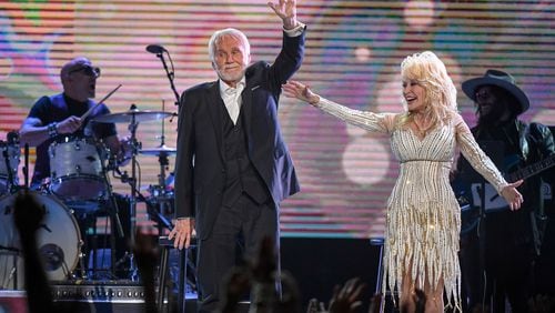Kenny Rogers and Dolly Parton wave goodbye to the crowd after performing for the last time at the "All In For the Gambler" tribute to Rogers at Bridgestone Arena in Nashville on Oct. 25, 2017.