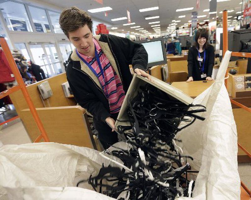 - East Cobb - Tor Wendel recycles hangers from the checkout stands Friday morning. Black Friday shoppers at Kohl's in East Cobb. Kohl's was among retailers opening Thursday evening and staying open until midnight Friday, nearly 30 hours later. BOB ANDRES /BANDRES@AJC.COM