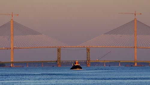 In this 2003 photo, a tugboat makes it's way to Colonel's Island to help take a cargo ship out to sea. In the background are the new and old Sidney Lanier bridges. The newest one spans the width of this photo, and is the largest bridge in Georgia, and one of the largest cable-stayed bridges in the world. The bridge will be dedicated April 7 after seven years of construction and a two-year delay in completion. (JOEY IVANSCO/AJC staff)