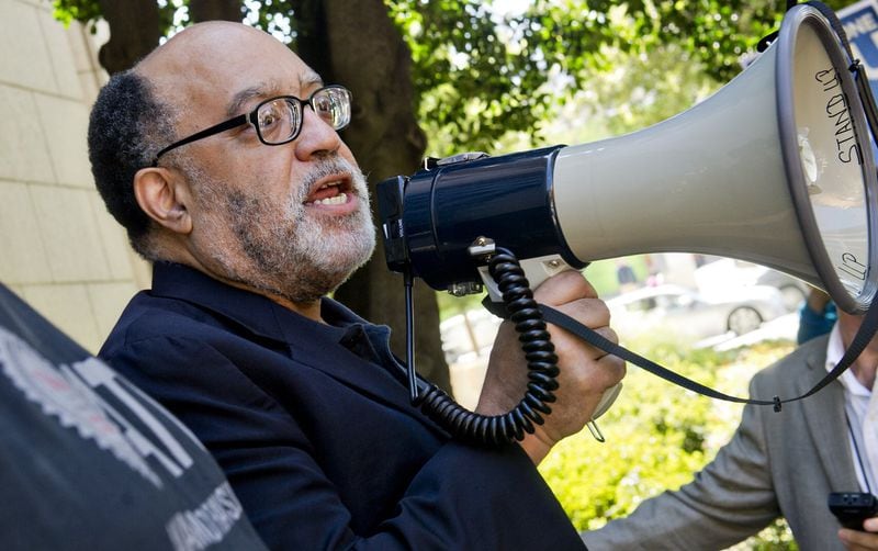 Then-senator Vincent Fort uses a bullhorn to speak to MARTA employees and retirees during union negotiations in front of the law offices of MARTA Board Chair Robbie Ashe on October 6, 2014, in Atlanta. JONATHAN PHILLIPS / SPECIAL