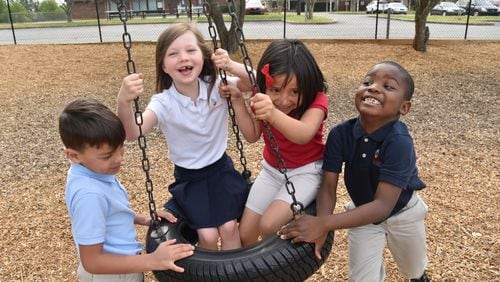 Kindergartners (from left) Ian DeOliviera, Eden Sterling, Ximena Benitez and Adam Ajayi, all 6, play at Carman Adventist School in Marietta earlier this month. These kids represent the new Cobb County, a county that is within just a few years of becoming majority minority. HYOSUB SHIN / HSHIN@AJC.COM