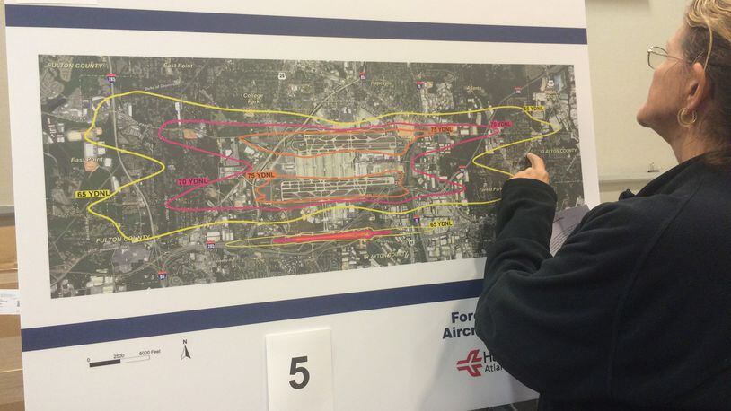 An airport area resident examines a map showing areas affected by airport noise at an open house at Hartsfield-Jackson. Credit: Kelly Yamanouchi.