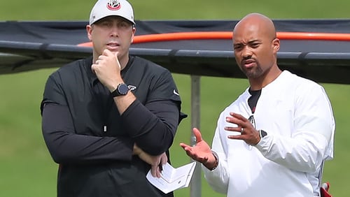 Falcons head coach Arthur Smith (left) and general manager Terry Fontenot (right) confer during team practice at mini-camp on Wednesday, Jun 10, 2021, in Flowery Branch.