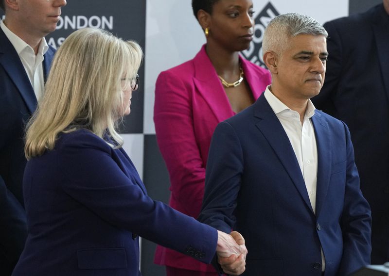 Conservative Party mayoral candidate Susan Hall, left, shakes hands with the winning Labour Party's Sadiq Khan on stage as he is re-elected for a record third time as Mayor of London, following the counting of votes, at City Hall in London, Saturday, May 4, 2024. Khan, the Labour Party's Mayor of London, has romped to victory, securing a record third straight term at City Hall, on another hugely disappointing day for the U.K.'s governing Conservatives ahead of a looming general election. (AP Photo/Alastair Grant)