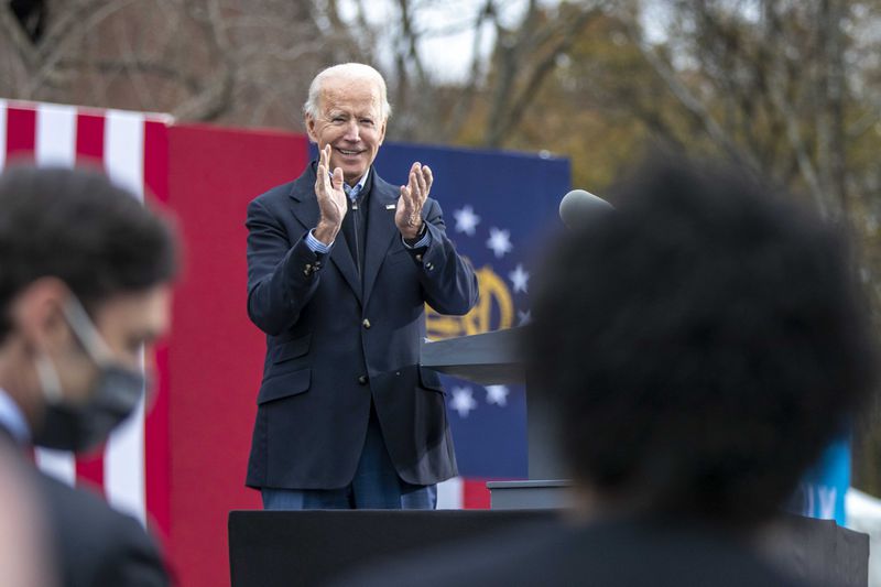 President-elect Joe Biden applauds Georgia Democrat leaders and candidates for U.S. Senate during a “Get Ready to Vote” rally at Pratt-Pullman Yard in Atlanta’s Kirkwood neighborhood, Tuesday, Dec. 15, 2020.  (Alyssa Pointer / Alyssa.Pointer@ajc.com)