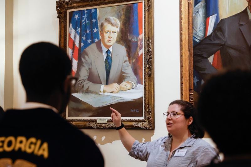 Georgia State Capitol museum educator Sophia Queen, talks about a painting of former President Jimmy Carter during a group tour on Tuesday, February 21, 2023. (Natrice Miller/The Atlanta Journal-Constitution)