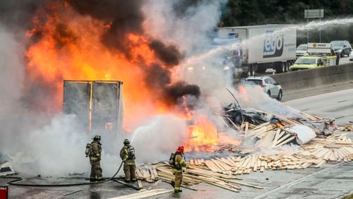 October 21, 2021 Fulton County: In the kind of calamity only possible in metro Atlanta traffic, two trucks carrying loads of lumber and candles collided on I-285 and burst into flames Thursday, Oct. 21, 2021. (John Spink / John.Spink@ajc.com)
