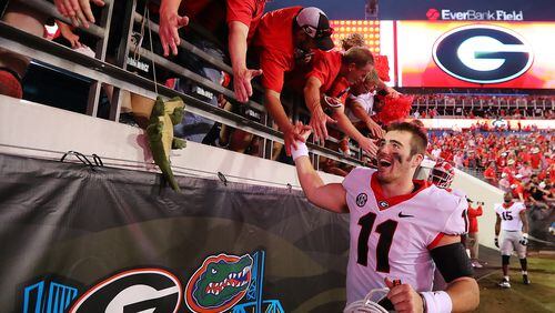 Georgia quarterback Jake Fromm celebrates the 42-7 win over Florida with fans.