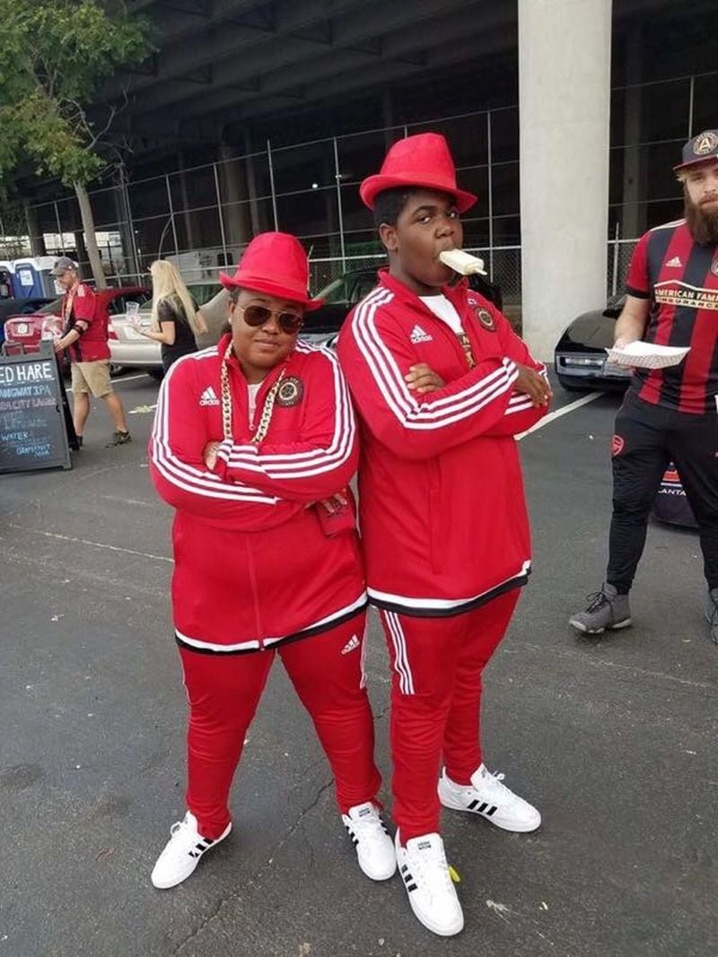 Ashley Robinson, and her son Quincy, who is 14, dress up as Run DMC for a Halloween tailgate. Robinson, a stock broker, DJs at tailgate parties before Atlanta United games.