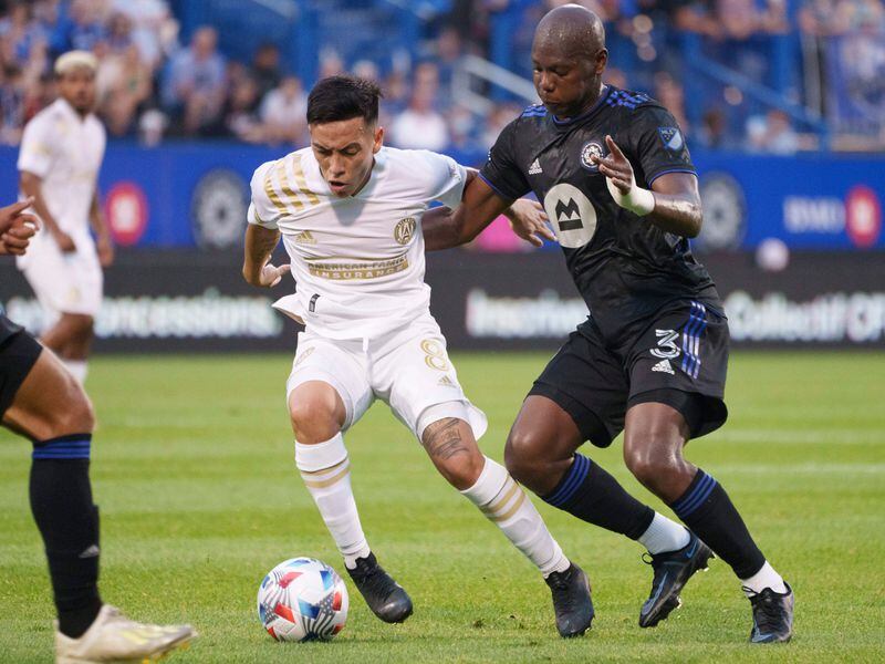 Atlanta United midfielder Ezequiel Barco fends off Montreal defender Kamal Miller (right) during the first half  Wednesday, Aug. 4, 2021, in Montreal. (Paul Chiasson/The Canadian Press via AP)