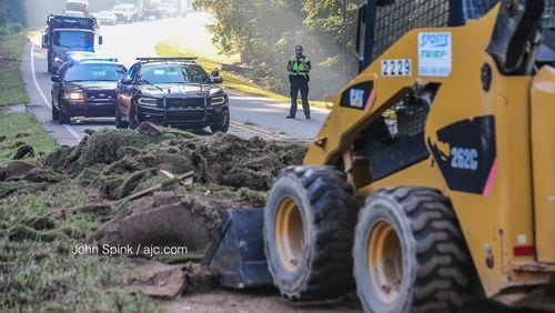 A truck lost an 8,000-pound load of sod, blocking a south Fulton County highway for hours early Wednesday. JOHN SPINK / JSPINK@AJC.COM