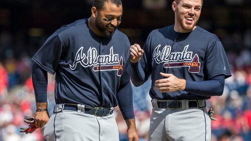 Freddie Freeman, right, laughs with Matt Kemp during a September win against the Phillies. Kemp was already hot at the plate but heated up further since the arrival of Kemp in the cleanup spot behind him in the batting order. (AP Photo/Chris Szagola)