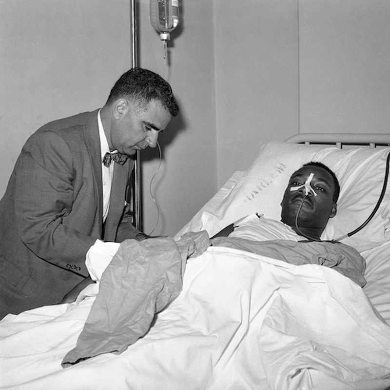 Dr. Emil A. Naclerio, member of the surgical team that operated on the Rev. Martin Luther King, at King’s bedside in Harlem Hospital in New York on Sept. 21, 1958. Rev. King, stabbed by Izola Ware Curry as he appeared at a Harlem Department store on September 20, was still on the critical list after an operation. (AP Photo/PL)