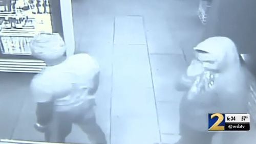 Surveillance video shows two men accused of robbing multiple metro Atlanta businesses.