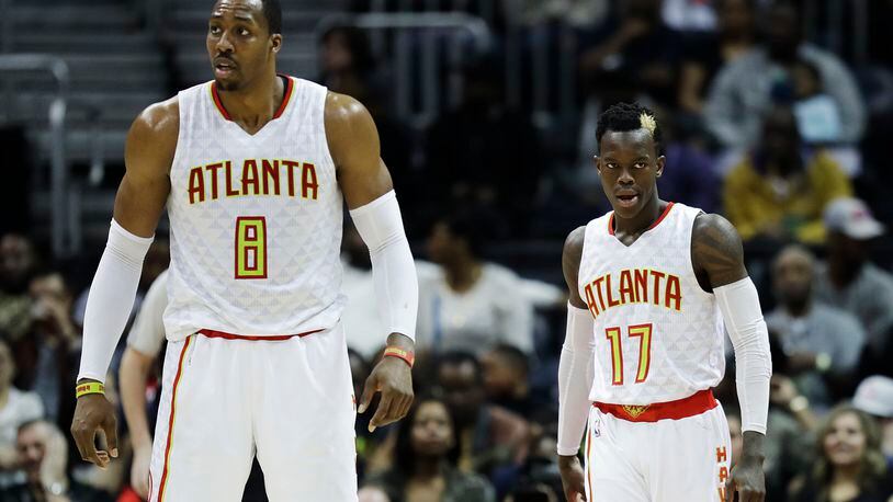 Atlanta Hawks’ Dennis Schroder and teammate Dwight Howard stand on the court in the fourth quarter of an NBA basketball game against the Brooklyn Nets in Atlanta, Wednesday, March 8, 2017. (AP Photo/David Goldman)