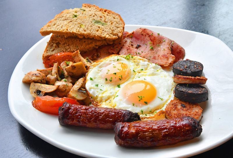 The Fadó Irish Breakfast is a skillet filled with Irish sausages, rashers (which are similar to Canadian bacon), black and white pudding (which are like pork sausage patties), tomatoes, mushrooms and eggs, with some Guinness Cheddar Bread on the side. STYLING BY BRYAN MCALISTER / CONTRIBUTED BY CHRIS HUNT PHOTOGRAPHY