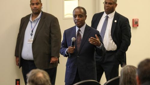 DeKalb CEO Michael Thurmond (center) and officials from the Department of Watershed Management talk to residents of Decatur, Ga. He presented the plans of an upcoming project to rectify sewer spill issues near Oakhurst on Tuesday, March 10, 2020. MIGUEL MARTINEZ FOR THE ATLANTA JOURNAL-CONSTITUTION