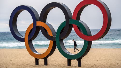 GANGNEUNG, SOUTH KOREA - FEBRUARY 02: A man walks past Olympic rings on the beach near the Gangneung Coastal Cluster on February 2, 2018 in Gangneung, South Korea. Finishing touches are being completed as teams begin to arrive from around the world to take part in the 23rd Winter Olympics. (Photo by Carl Court/Getty Images)