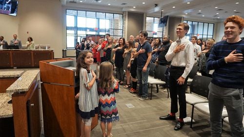 The Pledge of Allegiance at a recent Cherokee County School Board meeting is led by children of newly appointed assistant principal Julie Dutko. CHEROKEE COUNTY SCHOOLS