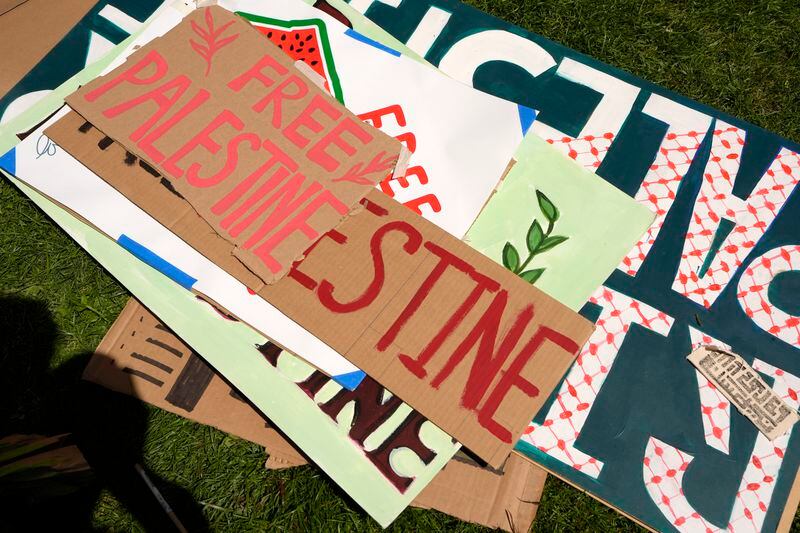 Placards lay on the ground outside an entrance to a building at Rhode Island School of Design that has been partially taken over by students and supporters, Tuesday, May 7, 2024, in Providence, R.I. The activists are demanding that RISD condemn Israel's war effort in Gaza, and that the school divest from investments that benefit Israel. (AP Photo/Steven Senne)