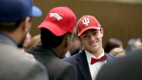 Alpharetta’s Austin King, committed to Indiana University on Feb. 4, 2015. Here, he talks to his teammates during the Signing Day festivities at the College Football Hall of Fame.  (AJC / JASON GETZ)