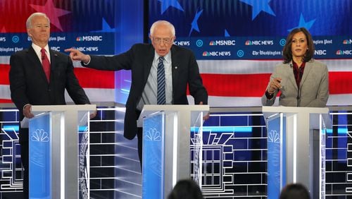 Joe Biden, left, clears the way for Senator Bernie Sanders, center, to make a point during a 2019 debate at Tyler Perry Studios in Atlanta. Biden, now running for reelection as president, will be back in Atlanta on June 27 to debate former President Donald Trump. (Alyssa Pointer/Atlanta Journal Constitution)