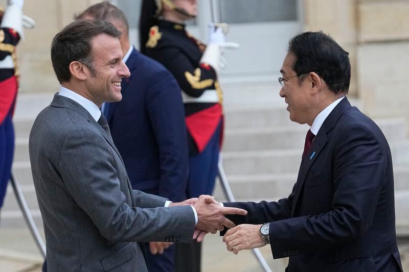 French President Emmanuel Macron, left, welcomes Japanese Prime Minister Fumio Kishida before a working lunch, Thursday, May 2, 2024 at the Elysee Palace in Paris. (AP Photo/Michel Euler)