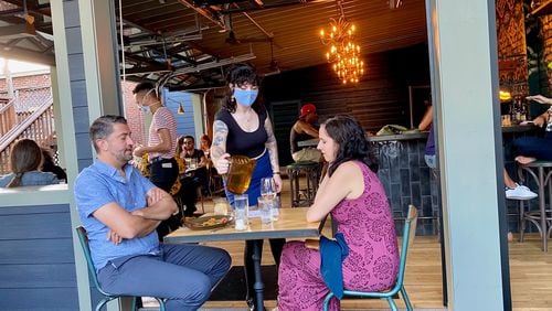 Banshee in East Atlanta Village has a room-like covered patio with a full bar, plus additional seating on the deck. 
Wendell Brock for The Atlanta Journal-Constitution