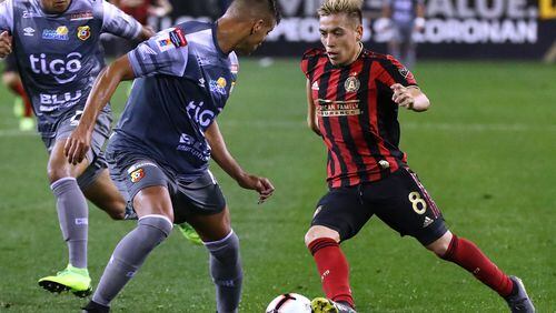 Atlanta United midfielder Esequiel Barco splits two C.S. Herediano defenders working the ball toward the goal in their Concacaf Champions League soccer match on Thursday, Feb. 28, 2019, in Kennesaw.    Curtis Compton/ccompton@ajc.com