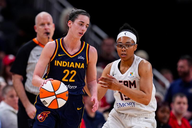 Indiana Fever guard Caitlin Clark (22) drives on Atlanta Dream guard Allisha Gray (15) during the first half of a preseason WNBA basketball game in Indianapolis, Thursday, May 9, 2024. (AP Photo/Darron Cummings)