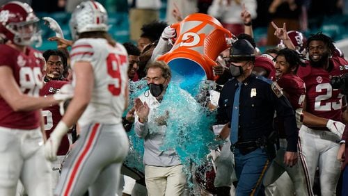 Alabama head coach Nick Saban is soaked in a sports drink after their win against Ohio State in the College Football Playoff championship game, Monday, Jan. 11, 2021, in Miami Gardens, Fla. Alabama won 52-24. (Lynne Sladky/AP)